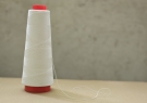 Paraffin-coated polyester thread